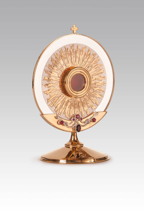 Gilded brass reliquary in the form of a host for one relic with a height of 37 cm